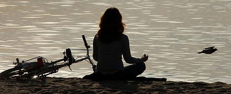 Mujer medita en la playa